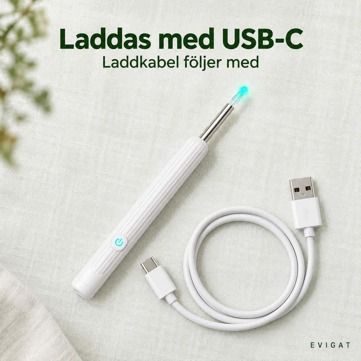 Öronrengörare med kamera och laddkabel med USB-C på en ljus yta
